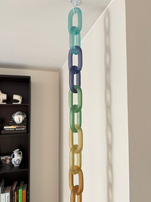 Colorful acrylic Infinity Links wall installation with rainbow tones, hanging as sculptural wall art.
