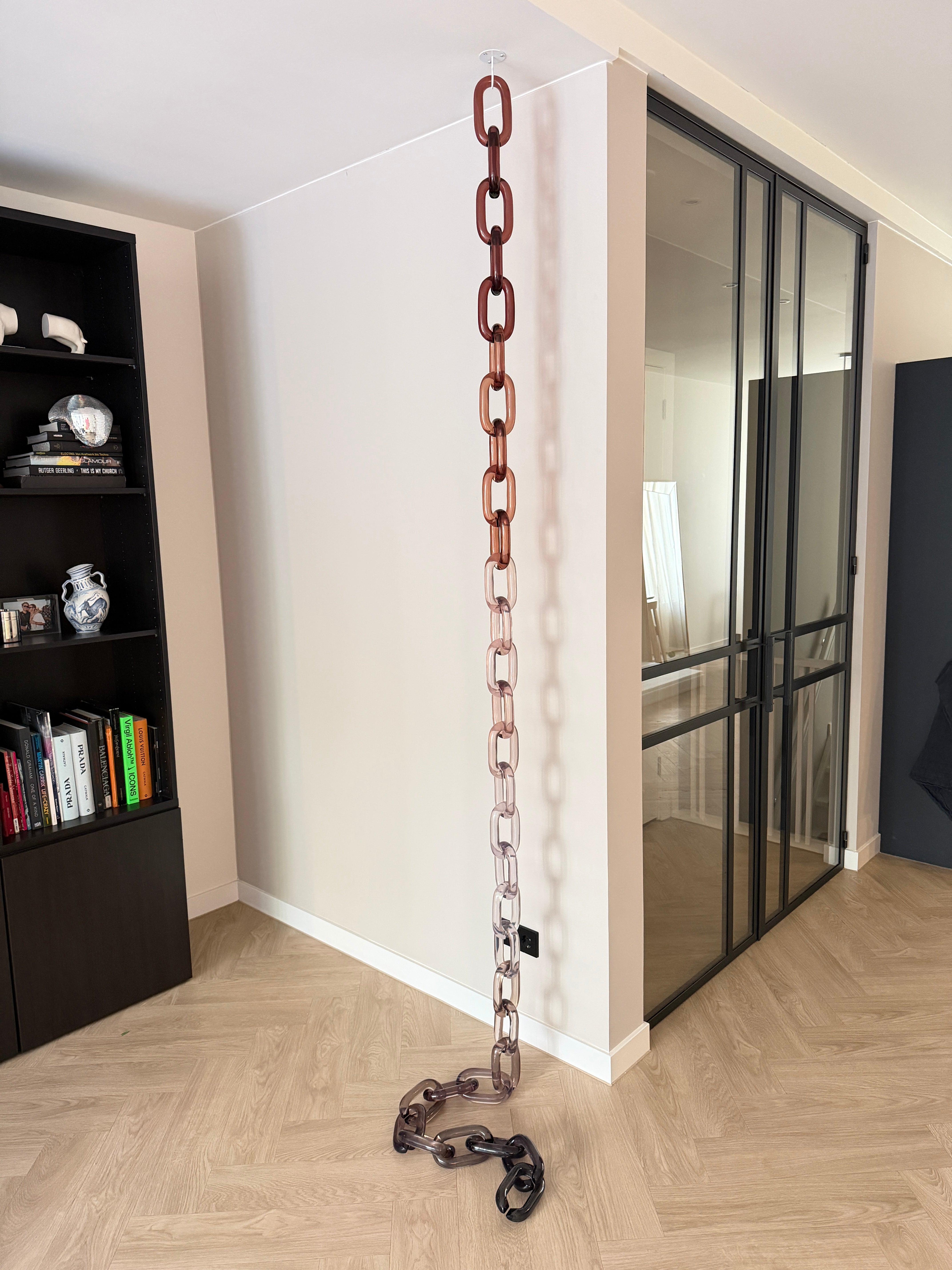 BRISÉNN Infinity Links displayed as a floor to ceiling acrylic art piece in a modern interior.