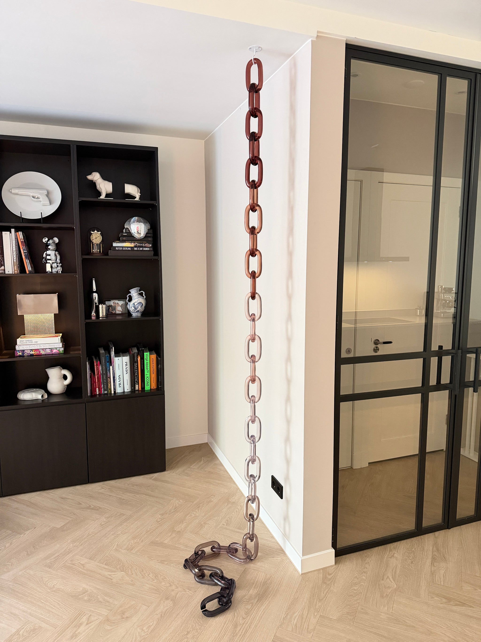BRISÉNN Infinity Links displayed as a floor to ceiling acrylic art piece in a modern interior.