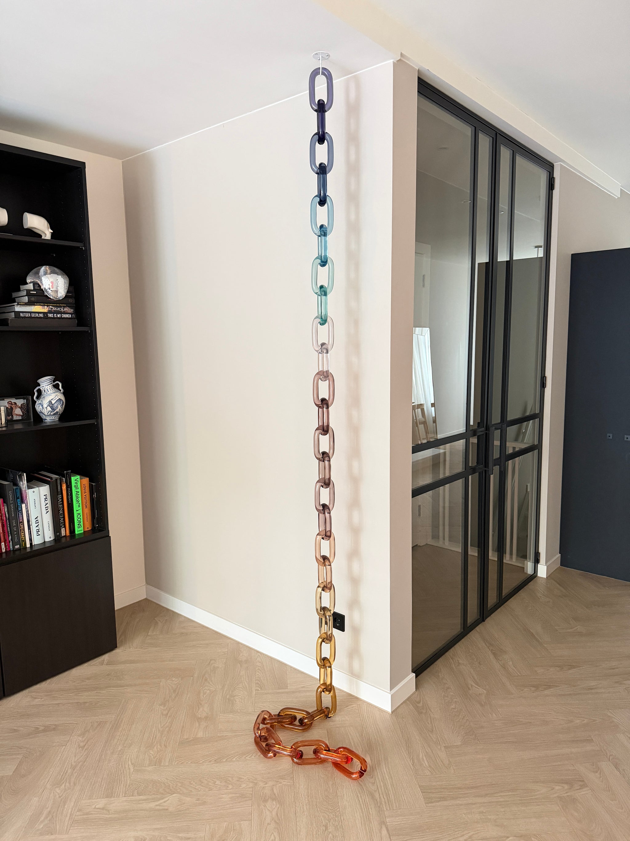 BRISÉNN Infinity Links displayed as a floor to ceiling acrylic art piece in a modern interior.