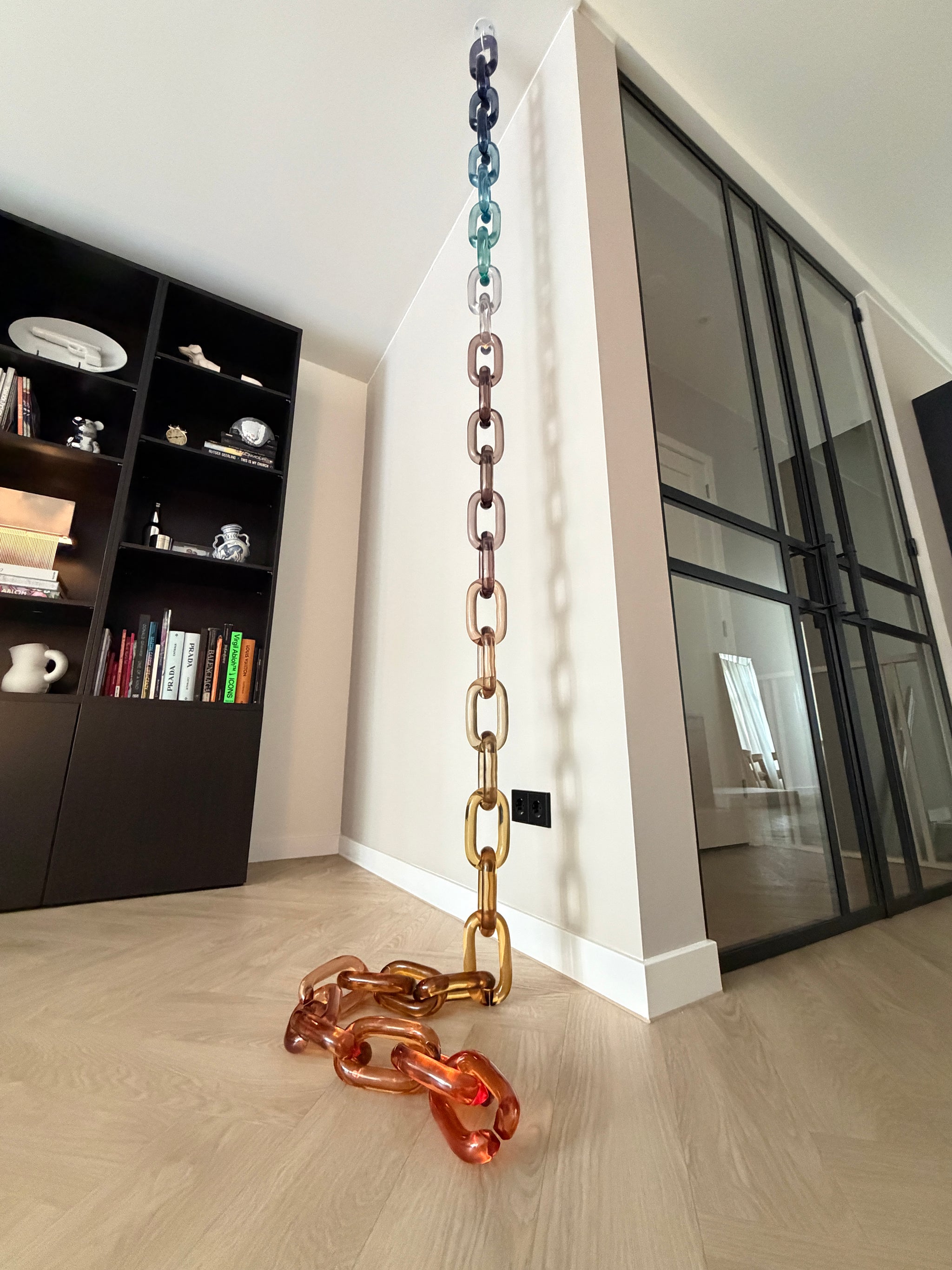 BRISÉNN Infinity Links displayed as a floor to ceiling acrylic art piece in a modern interior.