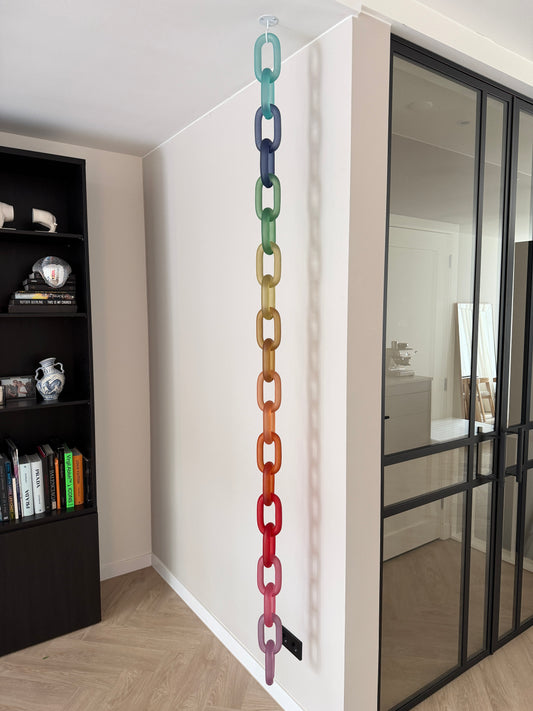 Colorful acrylic Infinity Links wall installation with rainbow tones, hanging as sculptural wall art.